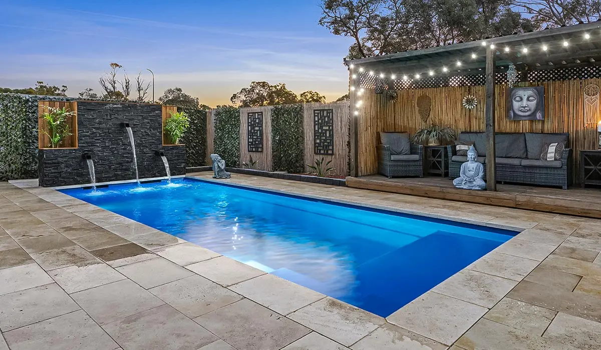Best-Types-of-Fiberglass-Pool-Coping-Hero.webp A beautiful blue pool with pool coping