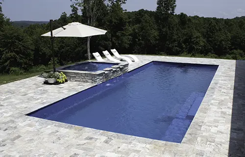 Leisure Pools The Grand rectangular fiberglass composite pool for lounging, installed by Leisure Pools Fort Wayne